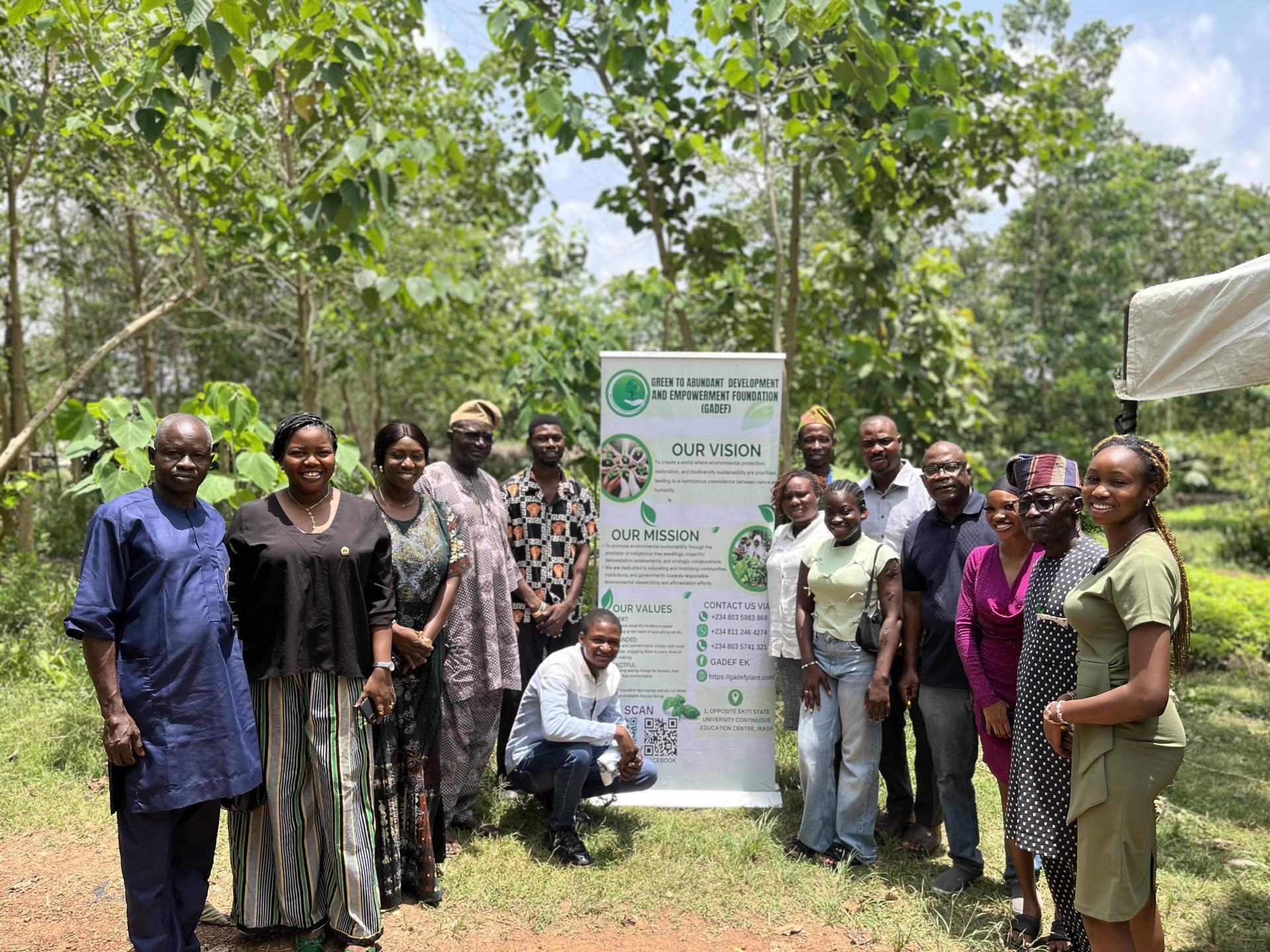 GADEF team with mission banner in forest setting